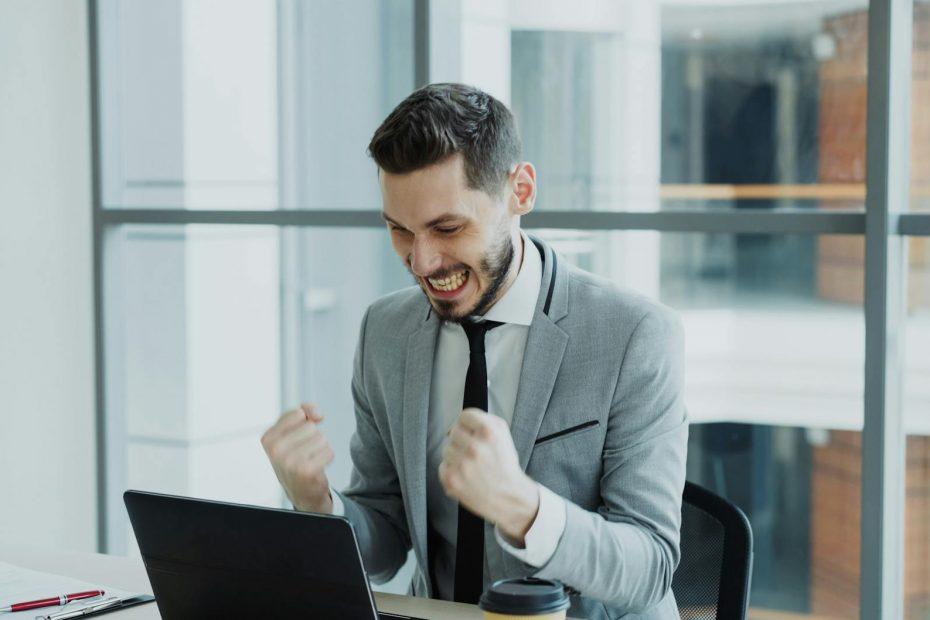 Business owner celebrating success after overcoming financial struggles.