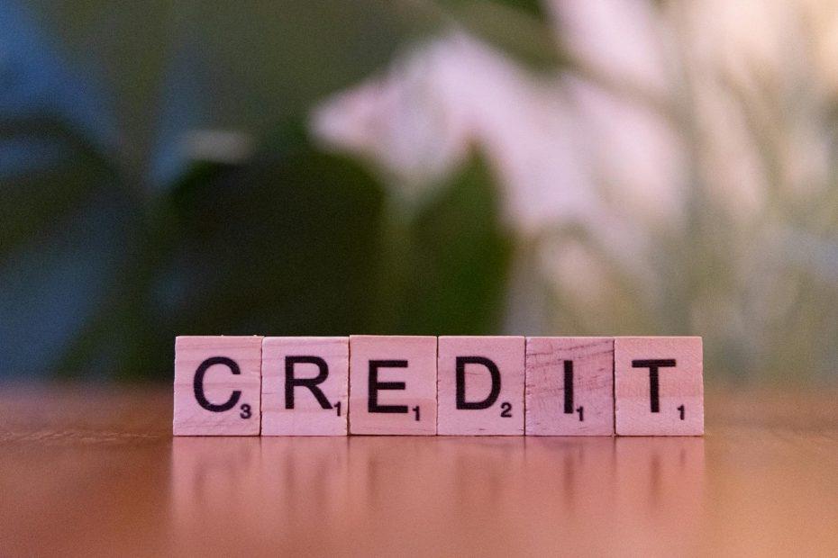 Chart showing upward trend with dollar signs and magnifying glass, indicating business credit score improvement.