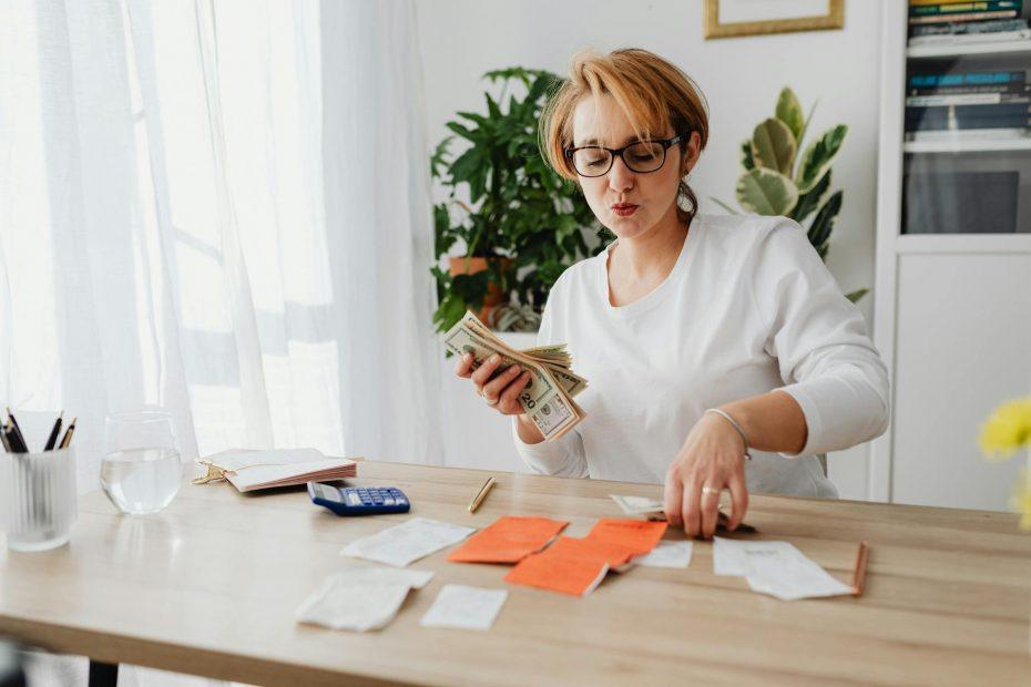 Man and woman looking at graphs and charts to reduce business expenses.